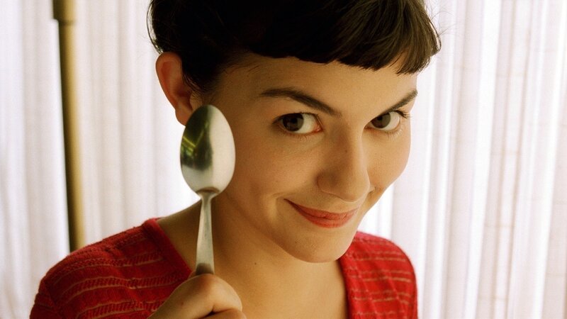 woman holding spoon near face