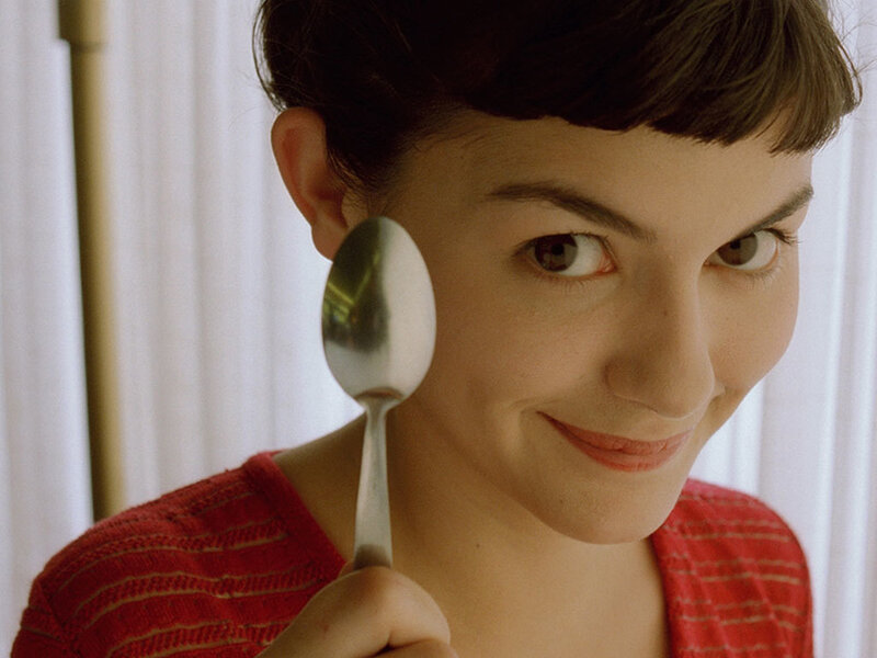 Woman holding spoon near face