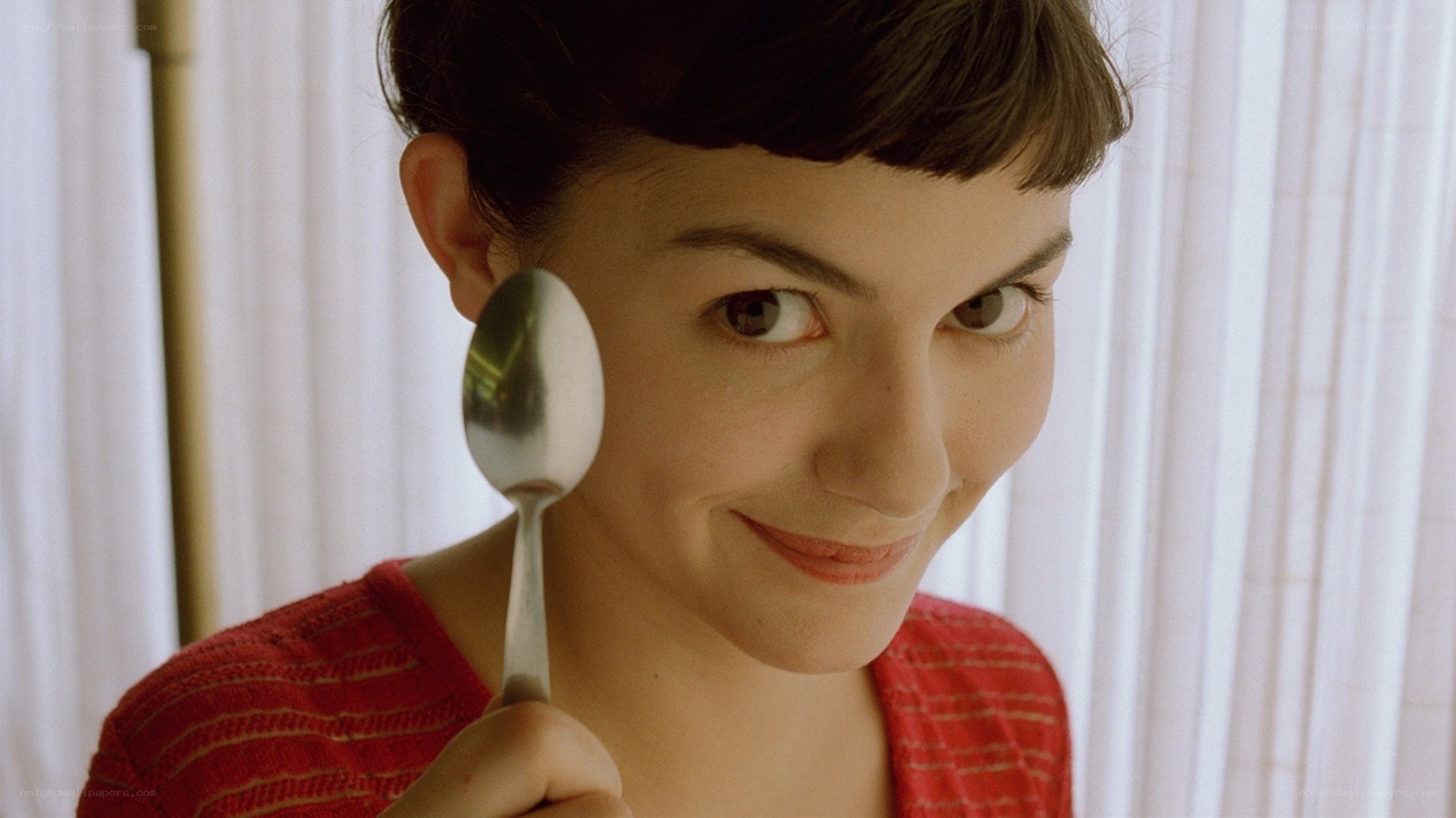 woman holding spoon smiling