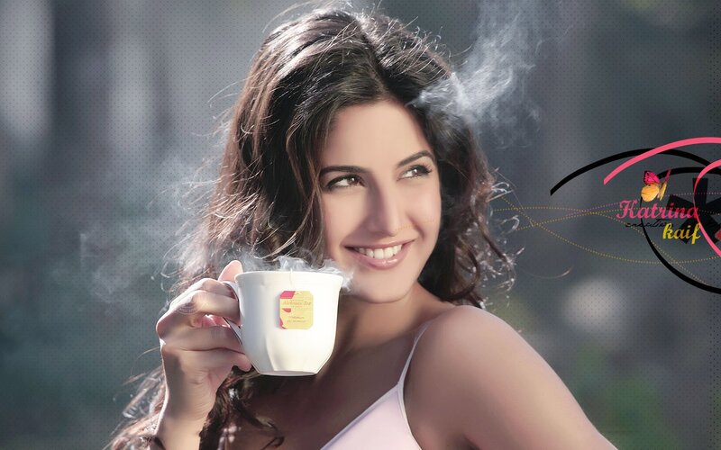woman holding steaming tea cup