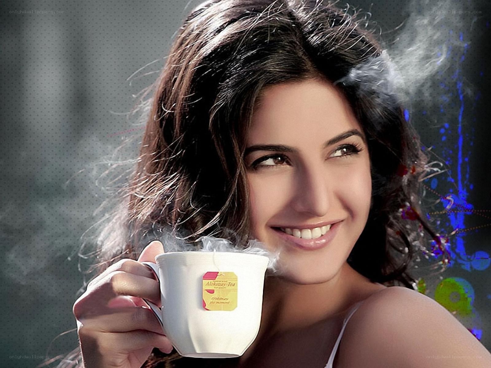 woman holding steaming tea cup