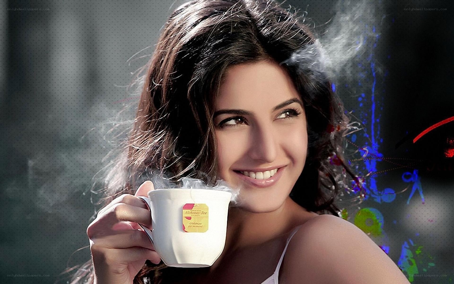 woman holding steaming tea cup
