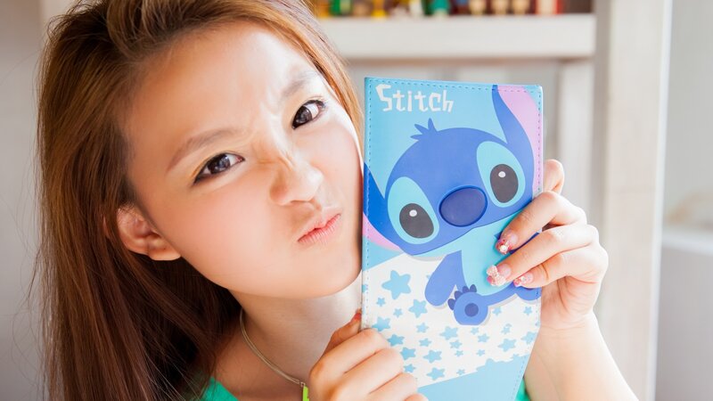 woman holding stitch wallet