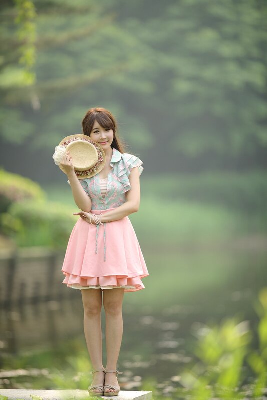 Woman Holding Straw Hat — Pink
