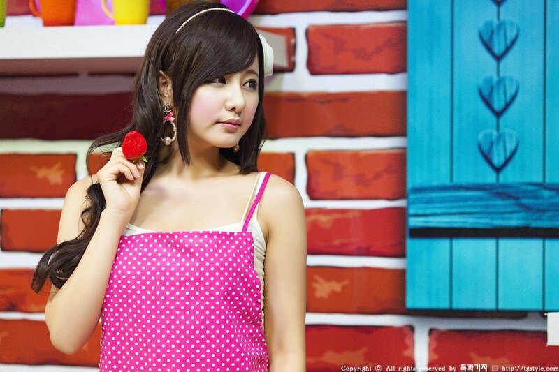 woman holding strawberry