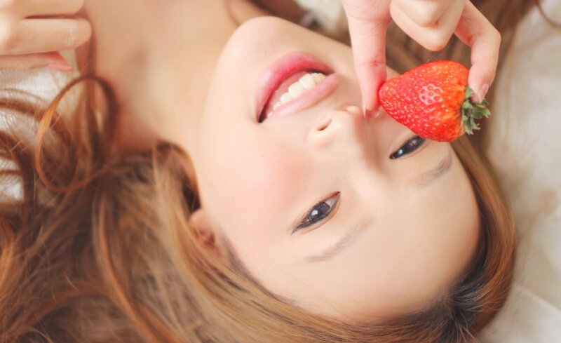 woman holding strawberry