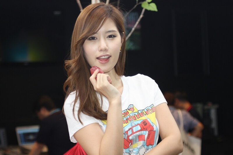 Woman holding strawberry at event