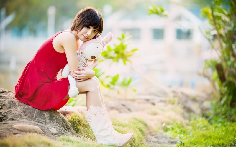 Woman Holding Stuffed Animal — Red, Serene