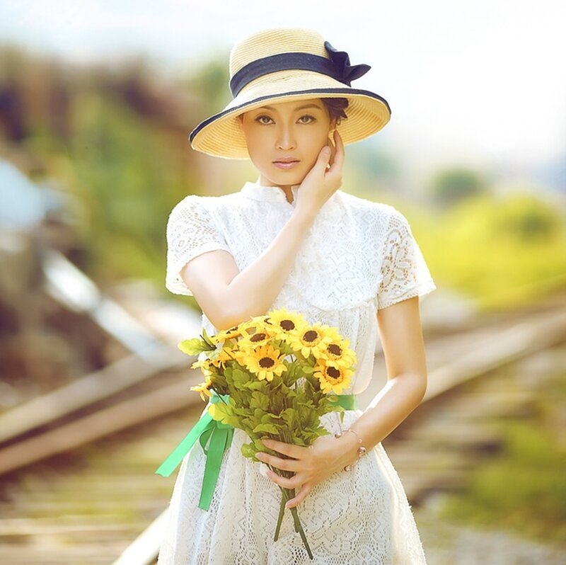 Woman Holding Sunflowers — White, Serene