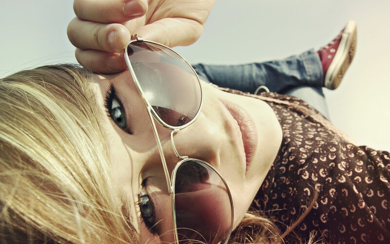 woman holding sunglasses