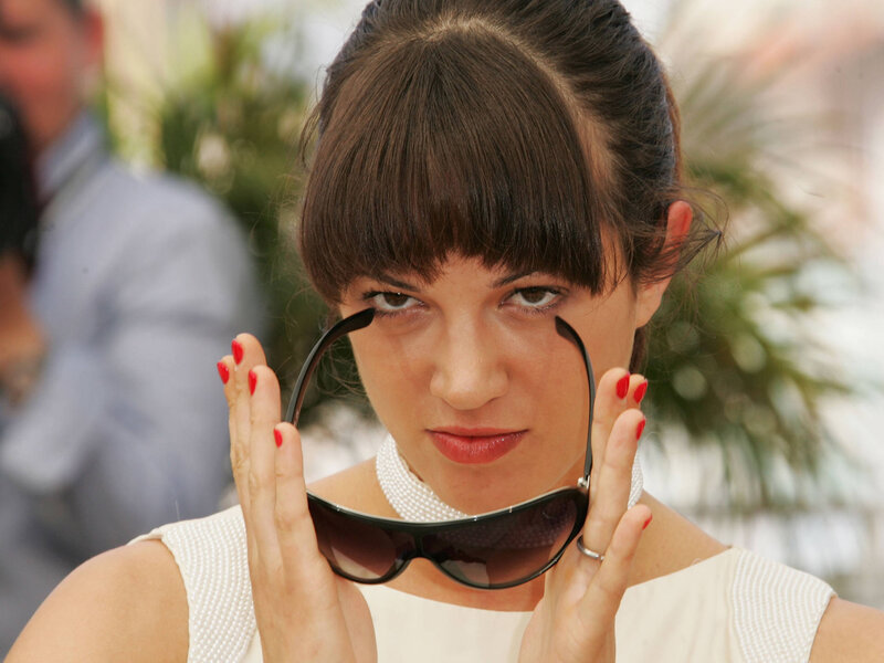 Woman holding sunglasses at event