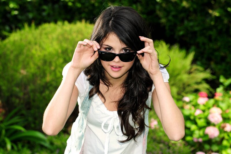 Woman Holding Sunglasses — Green