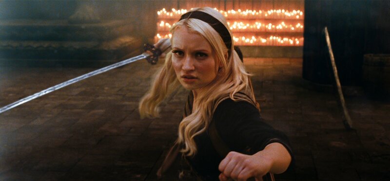 woman holding sword in candlelit room