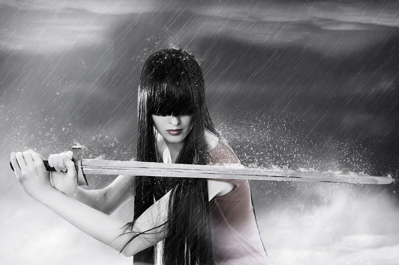 woman holding sword in rain