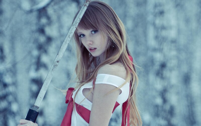 woman holding sword in snowy forest