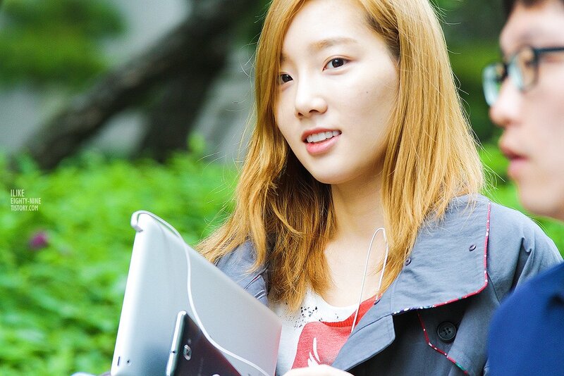 woman holding tablet outdoors