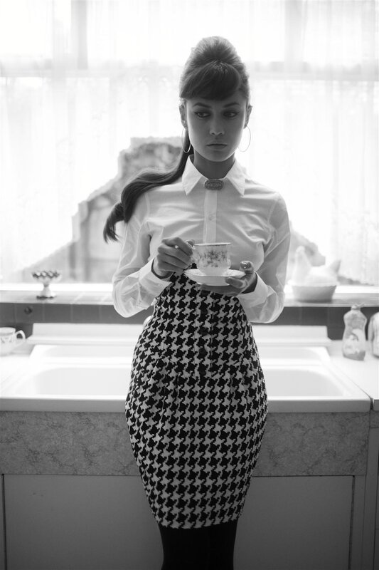 woman holding tea cup in kitchen