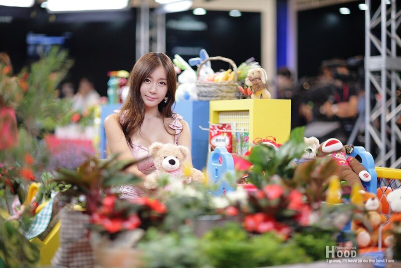 woman holding teddy bear at event