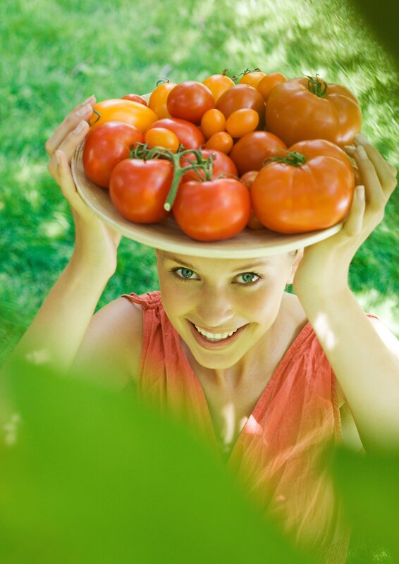 Woman holding tomatoes on head