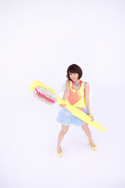 Woman Holding Toothbrush — Yellow, Playful