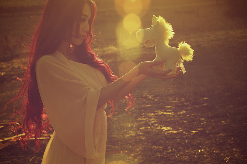 Woman Holding Toy Horse