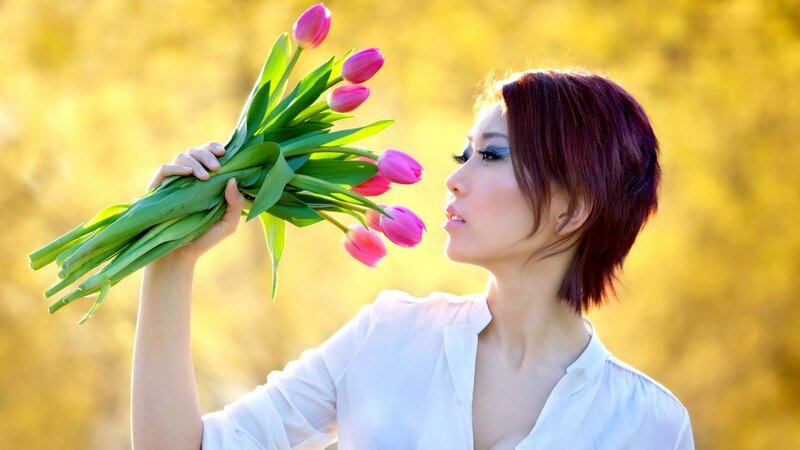 woman holding tulips in sunlight