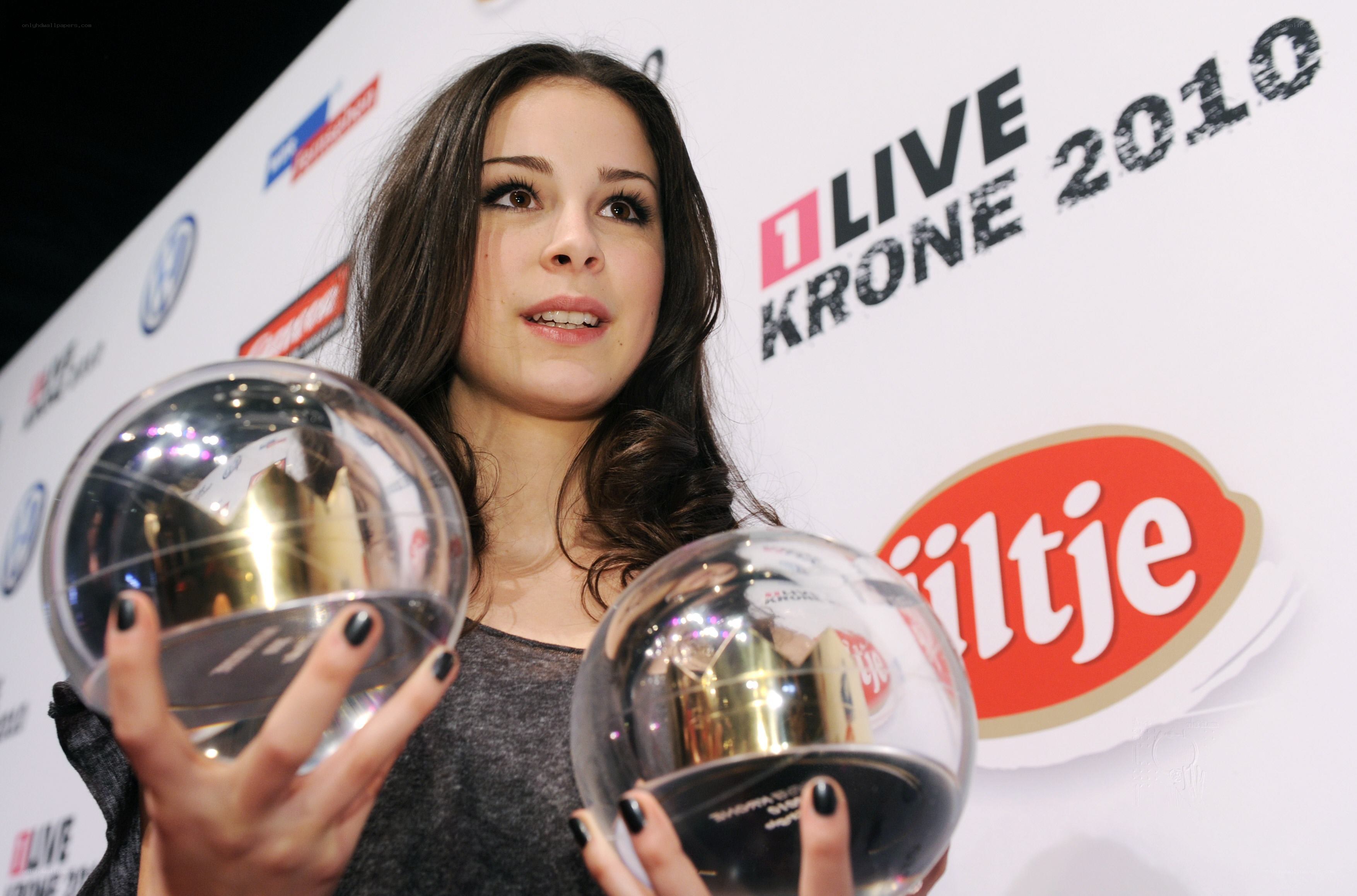 woman holding two awards