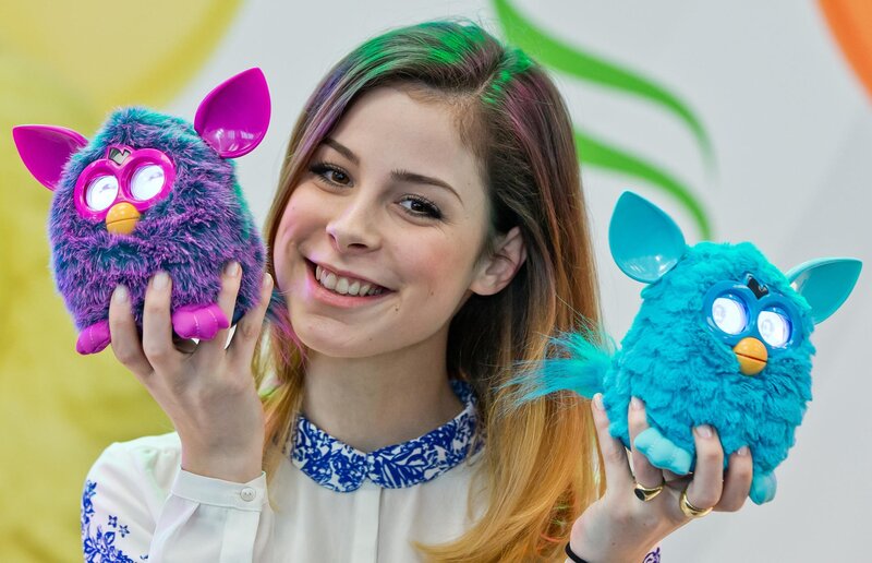Woman holding two Furby toys