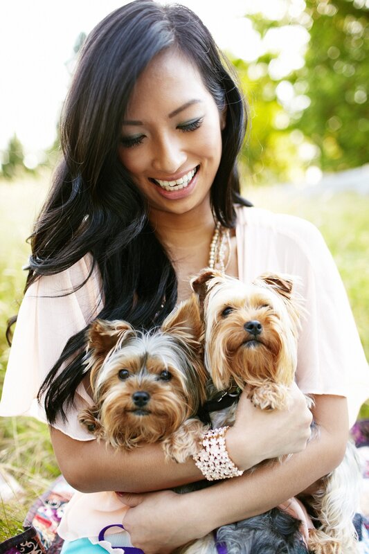 Woman holding two small dogs