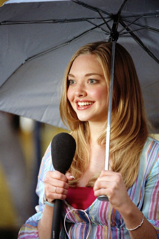 woman holding umbrella and microphone