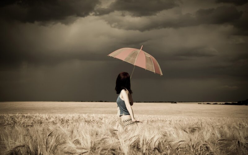Woman Holding Umbrella — Brown