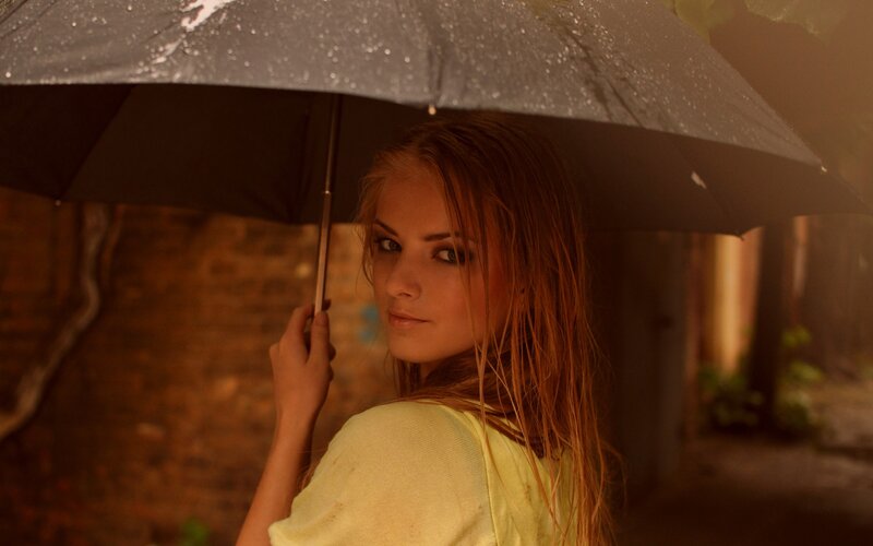 woman holding umbrella in rain