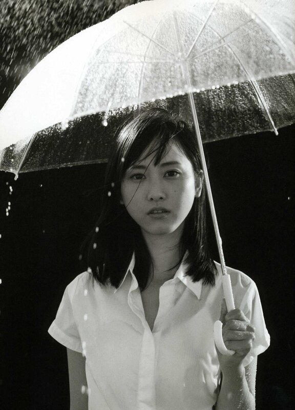 woman holding umbrella in rain