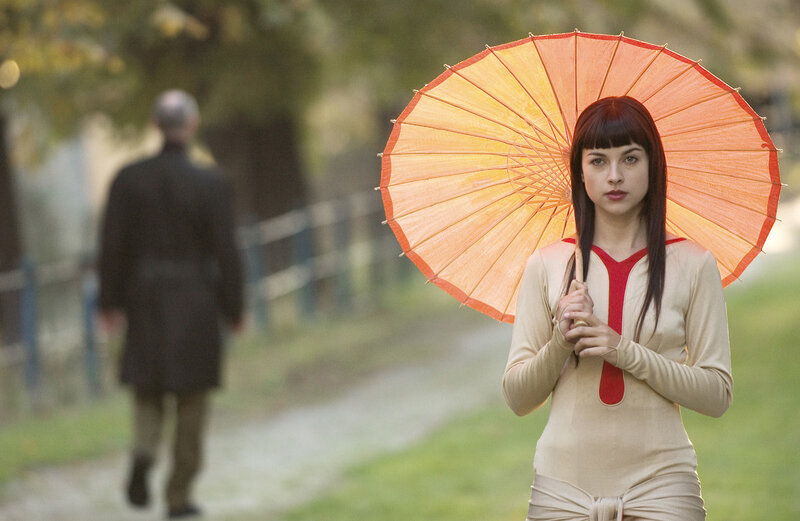 Woman Holding Umbrella — Orange, Contemplative