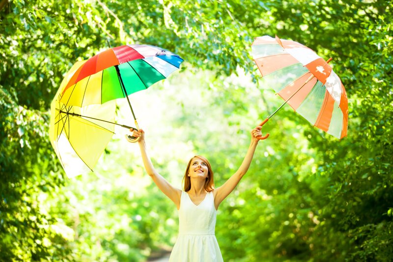 Woman Holding Umbrellas