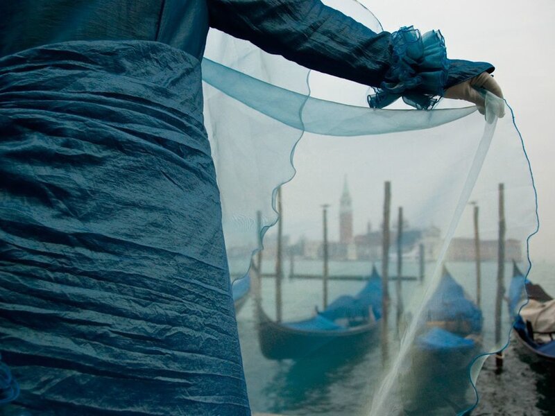 woman holding veil in venice