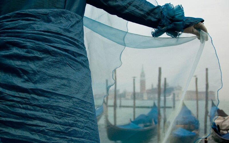 woman holding veil in venice
