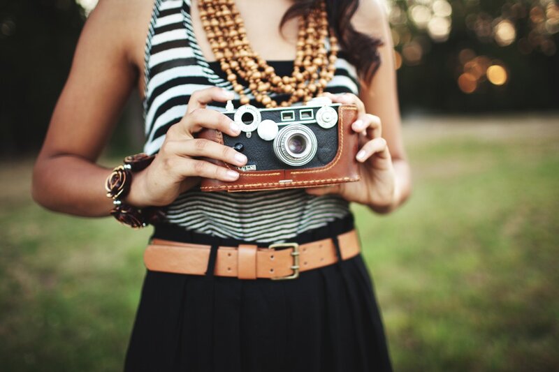 woman holding vintage camera