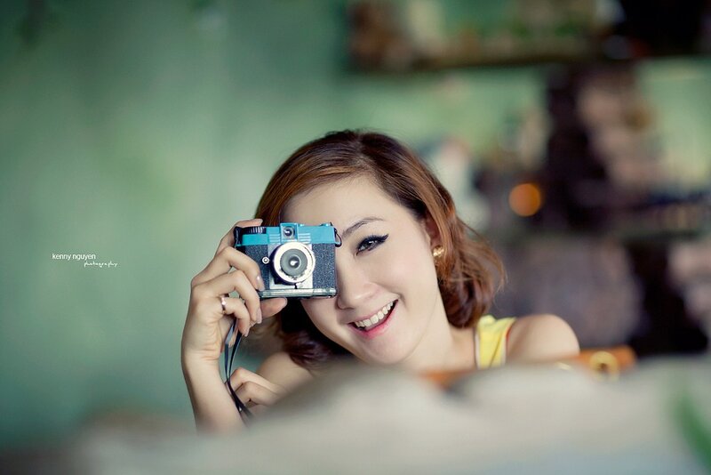 woman holding vintage camera
