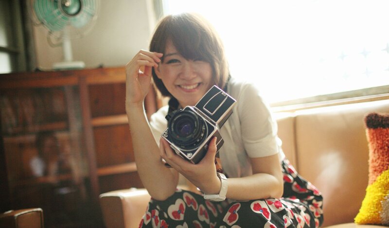 woman holding vintage camera