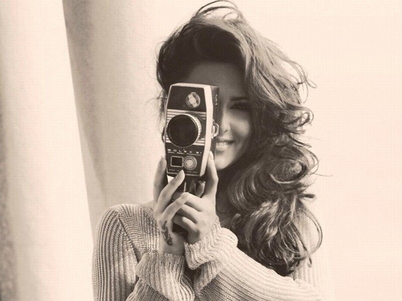 woman holding vintage camera