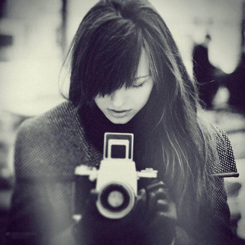 woman holding vintage camera
