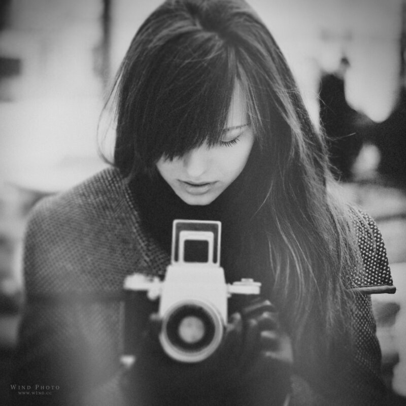 woman holding vintage camera