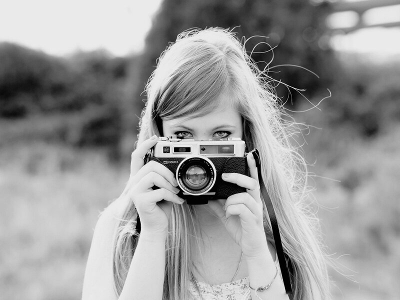 woman holding vintage camera