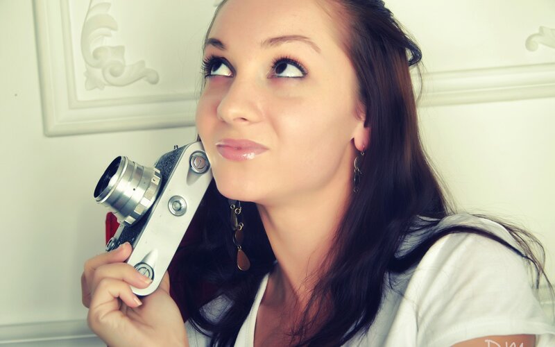 woman holding vintage camera