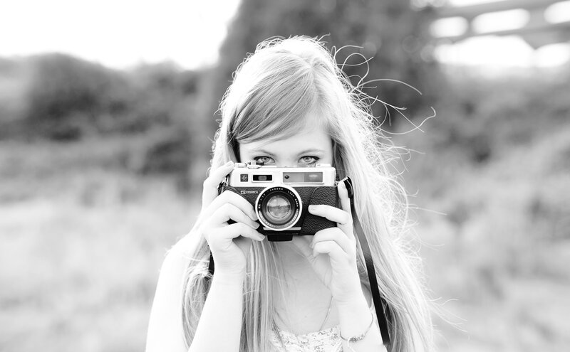 woman holding vintage camera