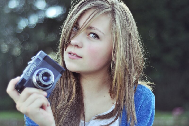 woman holding vintage camera