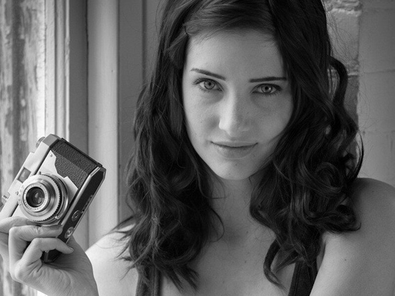 woman holding vintage camera