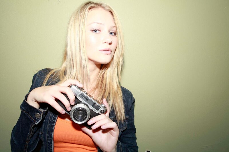 woman holding vintage camera