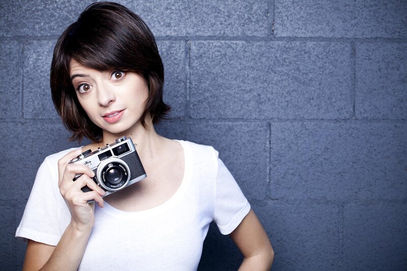 woman holding vintage camera